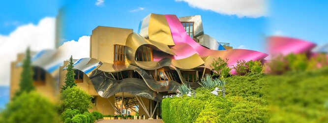 Trip Gardasee Reisetipps - Marqués de Riscal Design Hotel, Bilbao, Elciego, Spanien. Fantastisch galaktisch, unverkennbar ein Werk von Frank O. Gehry. Inmitten idyllischer Weinberge in der Rioja Region des Baskenlandes, bezaubert das schimmernde Bauobjekt mit einer Struktur bunter, edel glänzender verflochtener Metallbänder. Glanz im Baskenland - Es muss etwas ganz Besonderes sein. Emotional, zukunftsweisend, einzigartig. Denn in dieser Region, etwa 133 km südlich von Bilbao, sind Weingüter normalerweise nicht für die Öffentlichkeit zugänglich.